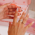 Girl applying Instant Mani press-on nail adhesive tabs