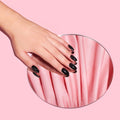 Girl wearing Instant Mani Co. short black press on nails in style Midnight