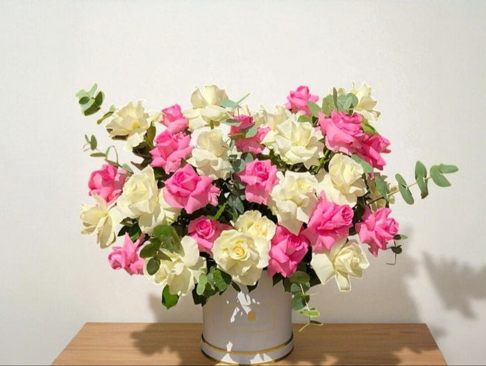Stems of mix roses in a round box